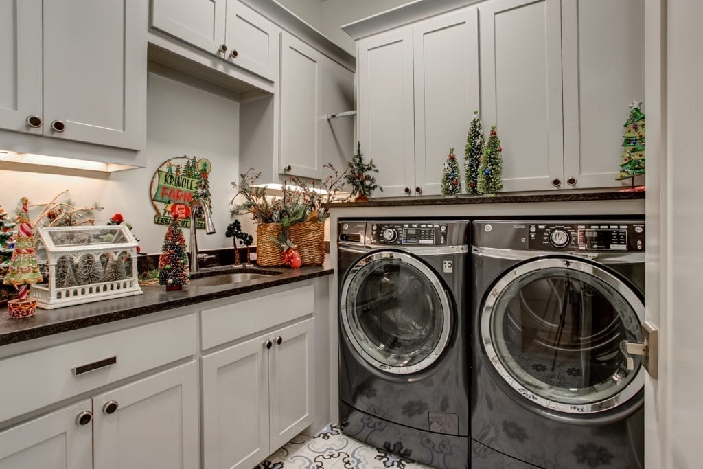 Laundry machines and a sink with holiday decorations