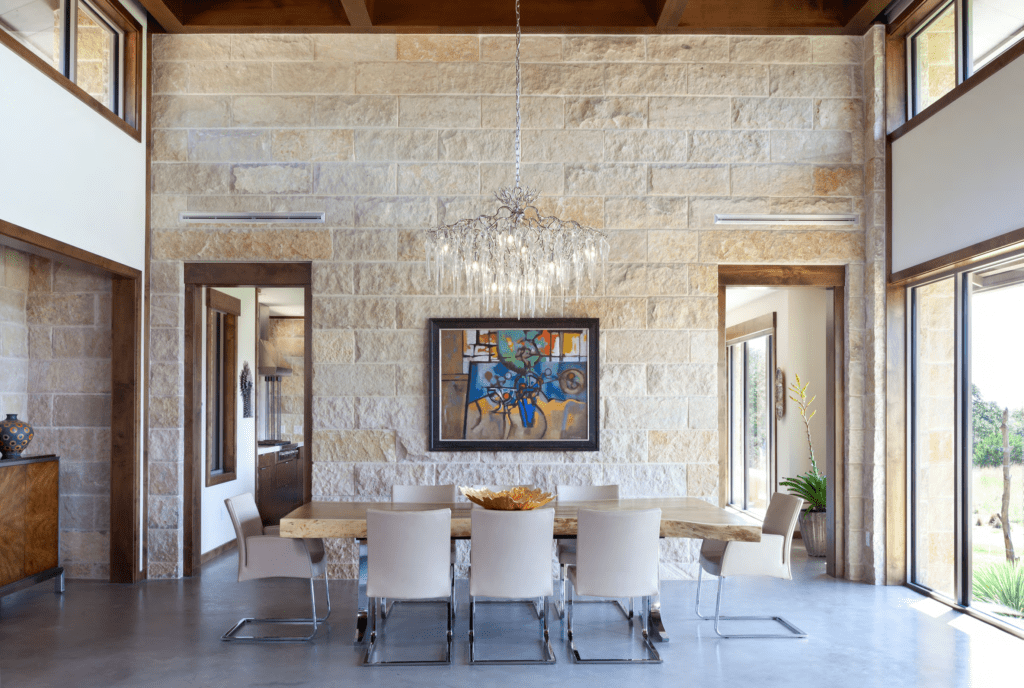 A painting and chandelier above the dining table