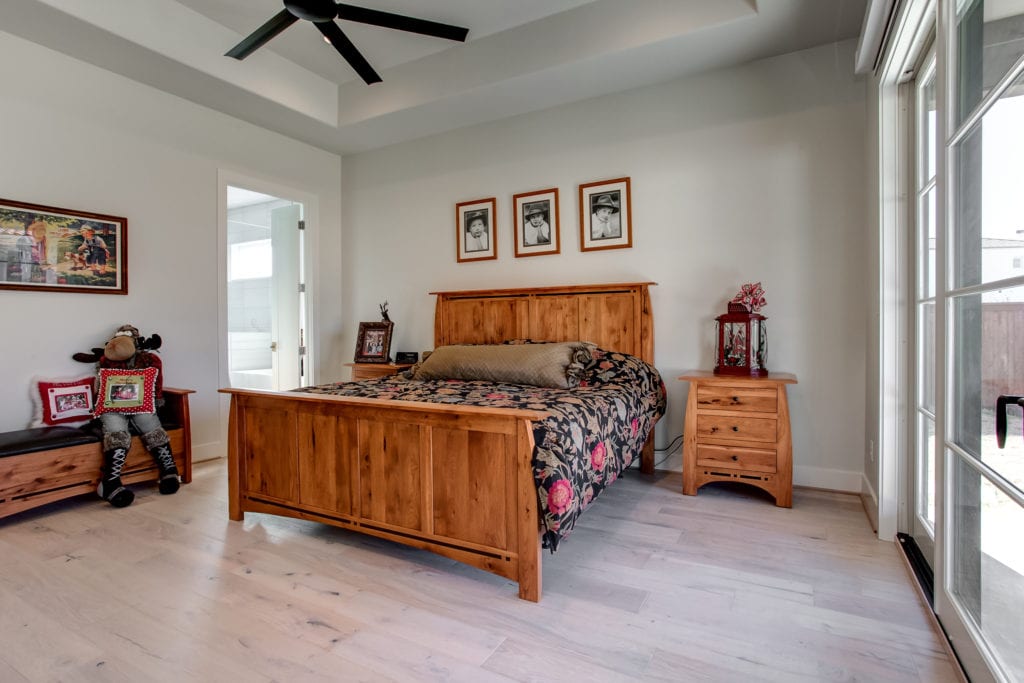 A furnished bedroom with portraits and holiday decorations