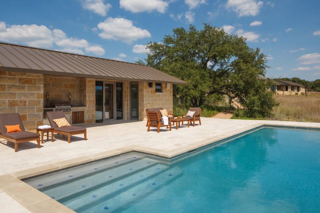 Outdoor lounge chairs by the swimming pool